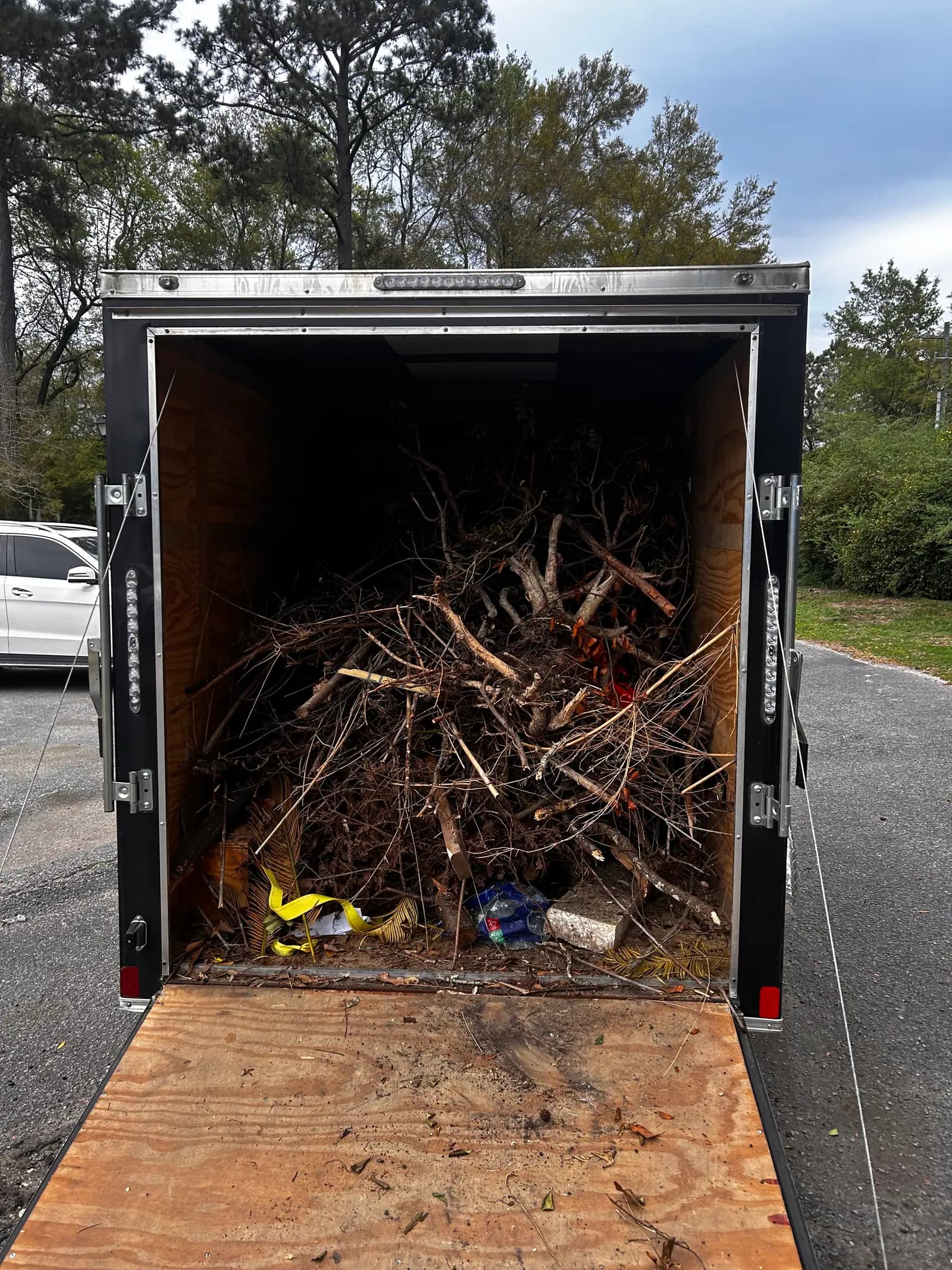 Trailer loaded with yard debris after a property refresh