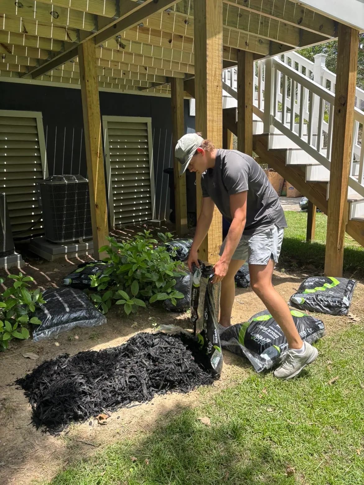 Crew member spreading mulch during a yard refresh