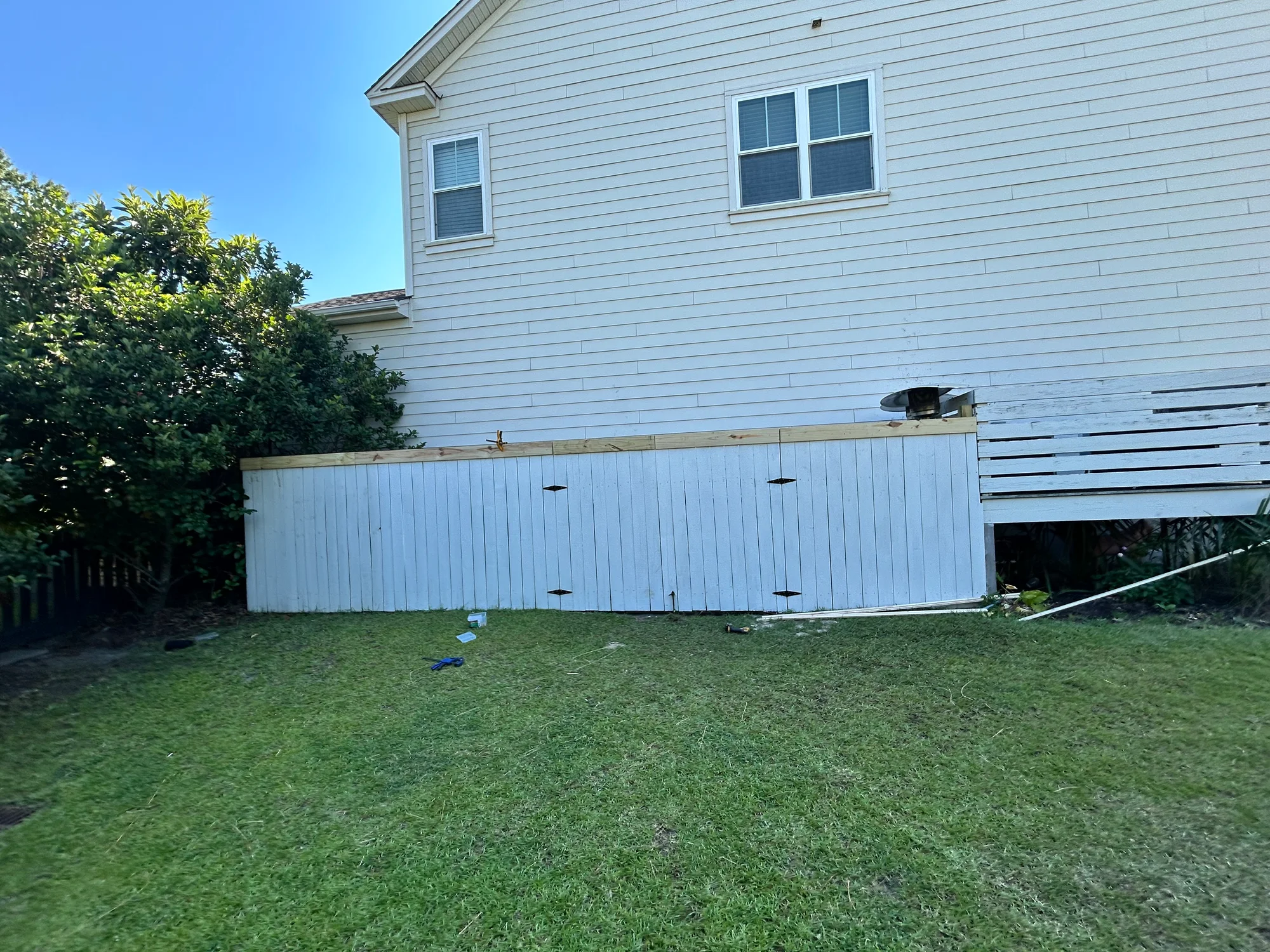 Finished low-profile backyard fence beside a Mount Pleasant home
