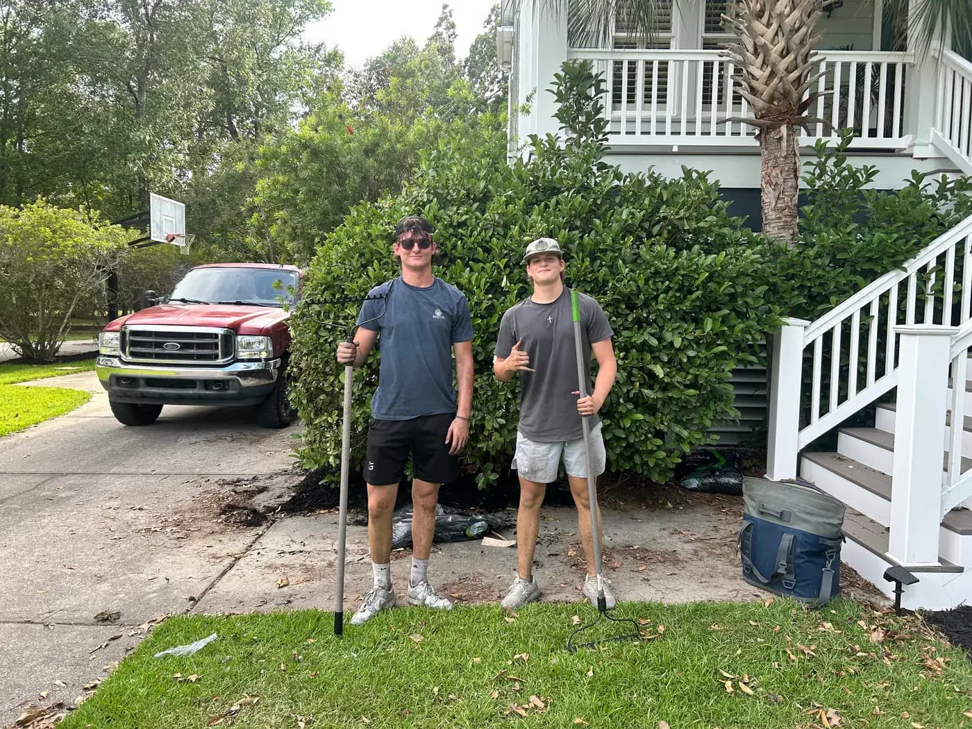 Two Palmetto Homecare crew members after a mulch project